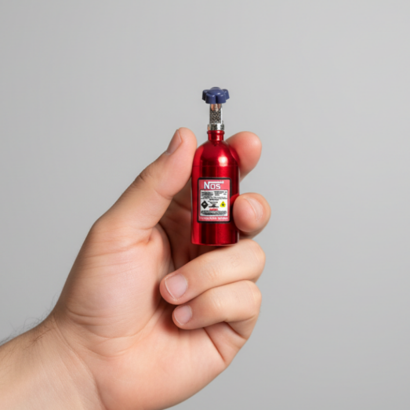 Small red bottle charm held in a hand with a blurred background