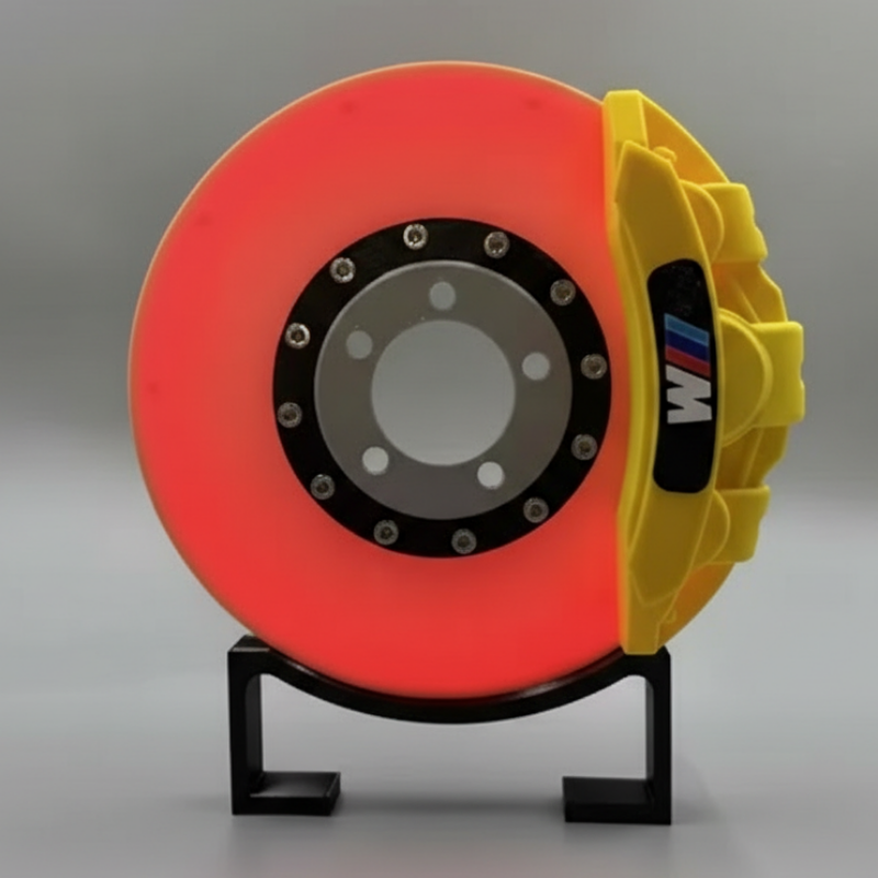 Brake disc with yellow caliper on a gray background