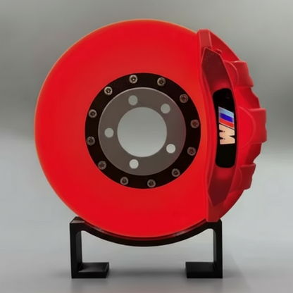 Red brake disc on a stand with a gray background