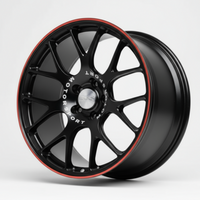 Black alloy wheel with red accents on a white background facing left