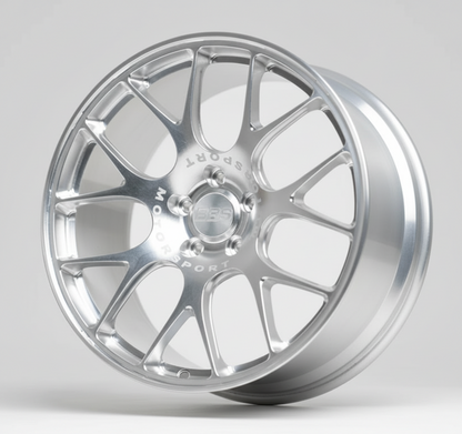 Silver alloy wheel on a stand against a white background facing left