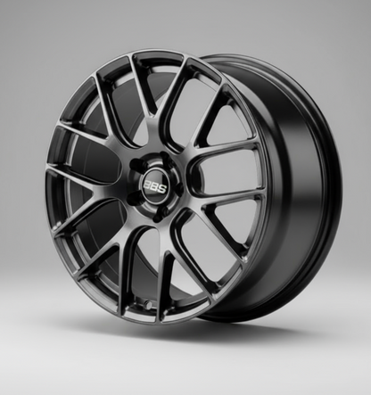 bbs rev7 wheel rim held by a hand against a blurred background