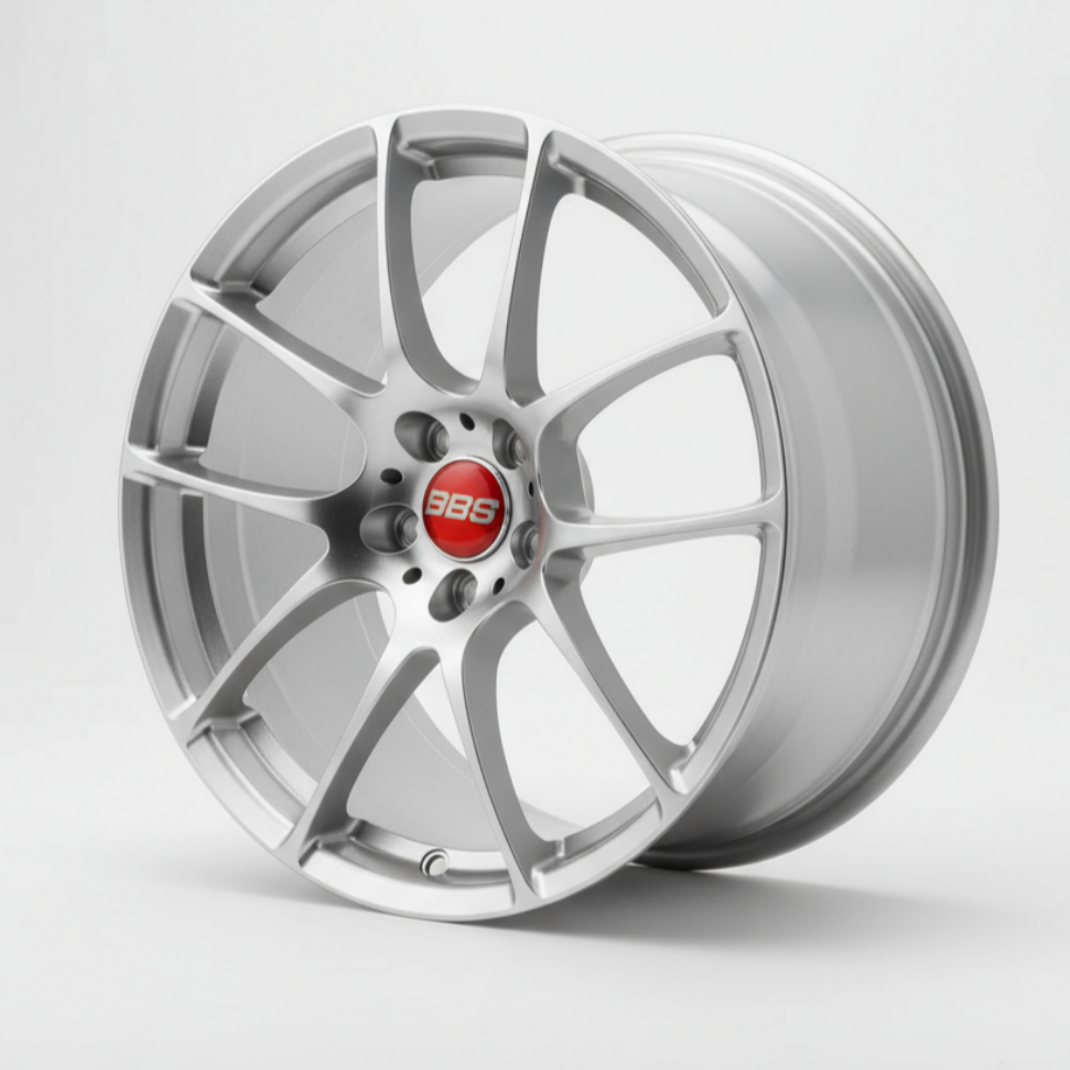 silver bbs rf wheel rim held by a hand against a green leafy background facing forward