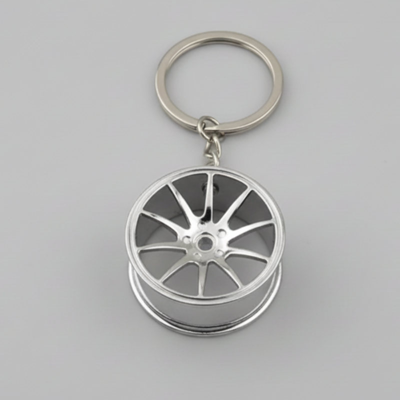 Keychain shaped like a car wheel rim on a dark background